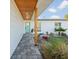 Inviting entrance with a covered walkway, custom door, and carefully landscaped area at 15810 2Nd E St, Redington Beach, FL 33708
