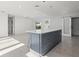 Open-concept kitchen features a large center island with white countertop and gray cabinets at 15810 2Nd E St, Redington Beach, FL 33708