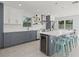 Modern kitchen with stainless steel appliances, white subway tile, and a large center island at 15810 2Nd E St, Redington Beach, FL 33708
