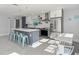 Stylish kitchen with an island, stainless appliances, and barstool seating at 15810 2Nd E St, Redington Beach, FL 33708