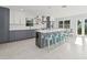 Spacious kitchen featuring a large island with a wine cooler, barstool seating, and stainless appliances at 15810 2Nd E St, Redington Beach, FL 33708