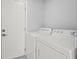 Bright laundry room with washer, dryer, and plenty of storage space at 15810 2Nd E St, Redington Beach, FL 33708