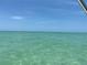 Beautiful view from the ocean of a boat sailing into the turquoise ocean underneath a sunny sky at 15810 2Nd E St, Redington Beach, FL 33708