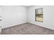 Simple bedroom with neutral carpeting and large window at 5381 Ulysses St, Port Charlotte, FL 33981