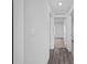 Bright hallway with vinyl plank flooring and doors to bedrooms at 5389 Ulysses St, Port Charlotte, FL 33981