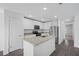 Modern kitchen with stainless steel appliances and an island with granite countertops at 5389 Ulysses St, Port Charlotte, FL 33981