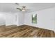 Bright and airy living room with wood-look flooring and a ceiling fan at 12157 Shellnut Ave, Port Charlotte, FL 33981