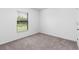 Simple bedroom with carpeted floors and a window with blinds at 12157 Shellnut Ave, Port Charlotte, FL 33981