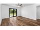 Bright bedroom with wood-look flooring and sliding glass doors at 5373 Ulysses St, Port Charlotte, FL 33981