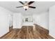 Spacious living room with wood-look floors and ceiling fan at 5373 Ulysses St, Port Charlotte, FL 33981