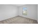 Bright bedroom featuring neutral wall paint and carpeted floors at 12169 Patterson Ave, Port Charlotte, FL 33981