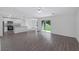 Spacious living room with grey laminate wood flooring and access to backyard at 12169 Patterson Ave, Port Charlotte, FL 33981