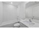 Modern bathroom with white tile, bathtub and vanity at 12169 Patterson Ave, Port Charlotte, FL 33981