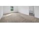 Spacious bedroom with neutral carpet and a view of the backyard at 12169 Patterson Ave, Port Charlotte, FL 33981