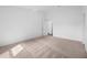 Spacious bedroom with neutral carpet and door to bathroom at 12169 Patterson Ave, Port Charlotte, FL 33981