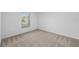 Well-lit bedroom with carpet flooring and a large window at 12169 Patterson Ave, Port Charlotte, FL 33981