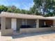 Exterior of a single story home with covered porch and mature trees at 36940 Howard Ave, Dade City, FL 33525