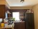 Kitchen with dark wood cabinets, gas stove, and refrigerator at 36940 Howard Ave, Dade City, FL 33525