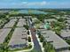 Aerial view of a neighborhood with townhomes, community pool, and a scenic lake in the background at 2220 Kings Palace Dr, Riverview, FL 33578