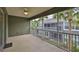 Screened-in outdoor living space offering views of palm trees and nearby buildings at 2220 Kings Palace Dr, Riverview, FL 33578