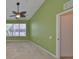 Light-filled bedroom with a ceiling fan, neutral carpet, and green walls at 2220 Kings Palace Dr, Riverview, FL 33578