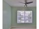 Bedroom with neutral green walls, ceiling fan, and ample light from a window at 2220 Kings Palace Dr, Riverview, FL 33578