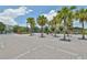 Gated entrance with palm trees, landscaped island, and brick-paved area offers community elegance at 2220 Kings Palace Dr, Riverview, FL 33578