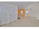 Bright and airy living room featuring neutral walls, two doors, and cozy carpet at 2220 Kings Palace Dr, Riverview, FL 33578