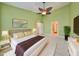 Bedroom with neutral colors, a king bed, nightstands and an ensuite bathroom at 2220 Kings Palace Dr, Riverview, FL 33578