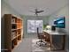 Office with a desk, ergonomic chair, shelving unit, and a modern ceiling fan at 2220 Kings Palace Dr, Riverview, FL 33578