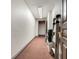 Hallway featuring a light-colored wall, pink carpet, and a door on the right side at 3507 Bayshore Blvd # 2001, Tampa, FL 33629