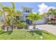 Light blue home with lush landscaping and a paver driveway at 421 Bahama Grande Blvd, Apollo Beach, FL 33572