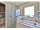Bathroom features a soaking tub, walk-in shower, and a large window at 421 Bahama Grande Blvd, Apollo Beach, FL 33572