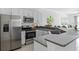 Modern kitchen with stainless steel appliances and granite countertops at 6916 Ripple Pond Loop, Zephyrhills, FL 33541
