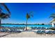 Beachfront view of a resort style pool and lounge chairs at 10413 Lavender Aster Trl, San Antonio, FL 33576