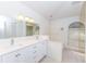 Bathroom featuring double sinks, quartz countertops, and modern lighting at 4787 Hamlets Grove Dr, Sarasota, FL 34235