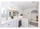 Bright bathroom features double sinks, a soaking tub, and stylish fixtures at 4787 Hamlets Grove Dr, Sarasota, FL 34235