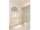 Bright bathroom featuring a glass enclosed shower, toilet, and stylish window with custom blinds at 4787 Hamlets Grove Dr, Sarasota, FL 34235