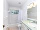 Clean bathroom features a tiled shower-tub combo, toilet, and vanity with a light green countertop at 4787 Hamlets Grove Dr, Sarasota, FL 34235
