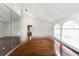 Spacious bedroom with hardwood floors, ceiling fan, and arched windows providing natural light at 4787 Hamlets Grove Dr, Sarasota, FL 34235