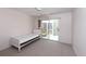 Cozy bedroom featuring a twin bed and sliding glass doors leading to the outside patio at 4787 Hamlets Grove Dr, Sarasota, FL 34235