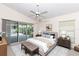 Tranquil bedroom with a ceiling fan, sliding glass doors to the patio, and neutral decor at 4787 Hamlets Grove Dr, Sarasota, FL 34235
