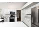 Bright kitchen with stainless steel appliances, white cabinets, and light countertops at 4787 Hamlets Grove Dr, Sarasota, FL 34235
