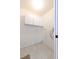 A dedicated laundry room features tile floors, overhead cabinets, and washer/dryer hookups at 4787 Hamlets Grove Dr, Sarasota, FL 34235
