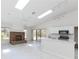 Bright open-concept living room with a brick fireplace and kitchen with stainless appliances at 4787 Hamlets Grove Dr, Sarasota, FL 34235