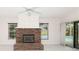 Living room featuring a brick fireplace and sliding glass doors leading to the pool at 4787 Hamlets Grove Dr, Sarasota, FL 34235