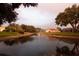Beautiful pond surrounded by mature landscaping and neighborhood homes at 4787 Hamlets Grove Dr, Sarasota, FL 34235