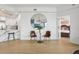 Elegant dining area with large round mirror, light wood floors, and modern chairs at 449 S 12Th St # 2405, Tampa, FL 33602