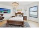 Spacious bedroom with large bed, chandelier, and hardwood floors at 449 S 12Th St # 2405, Tampa, FL 33602