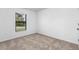 Simple bedroom with carpeted floor and a window at 5401 Gillot Blvd, Port Charlotte, FL 33981